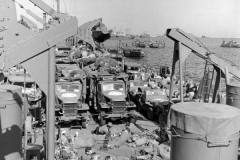 US personnel and vehicles on LST-317 in Portland Harbor near Weymouth England wait with other Allied vessels for the orders to depart for Normandy to participate in Operation Overlord - June 1-3 1944